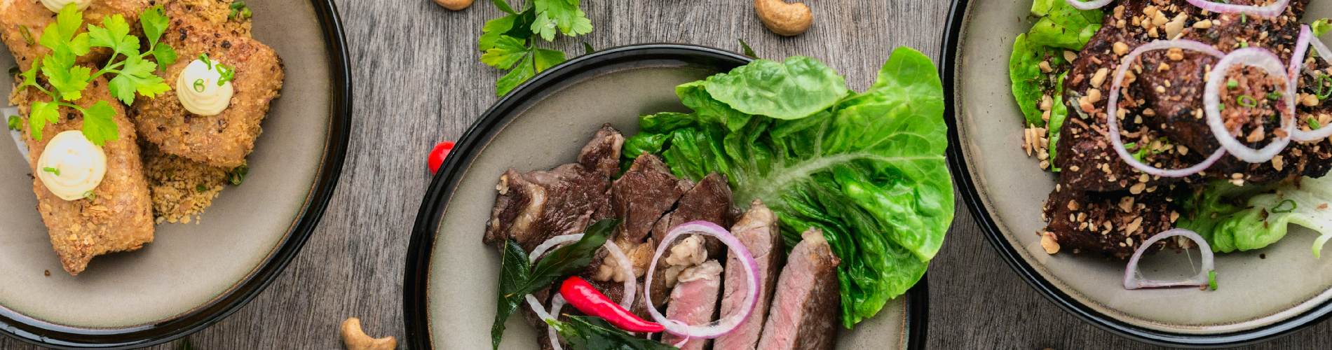 Lebanese food in three grey bowls, including fried tofu and some meat